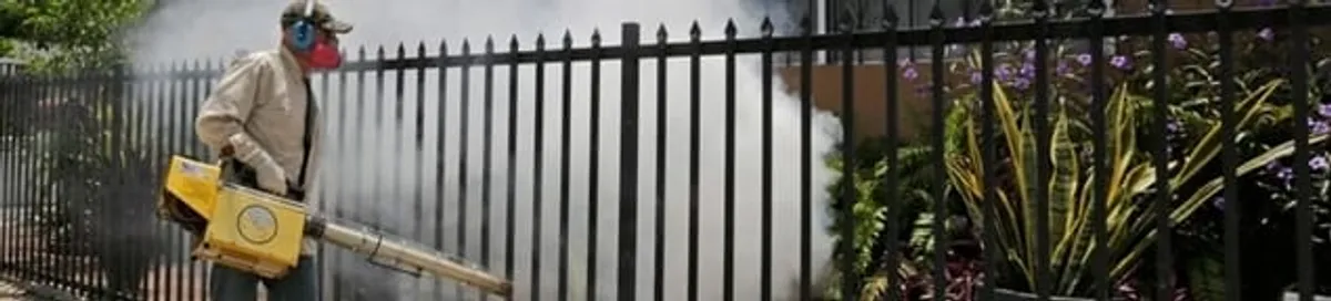 Mosquito control technician fogging a yard perimeter for mosquito reduction in Sioux Falls, SD